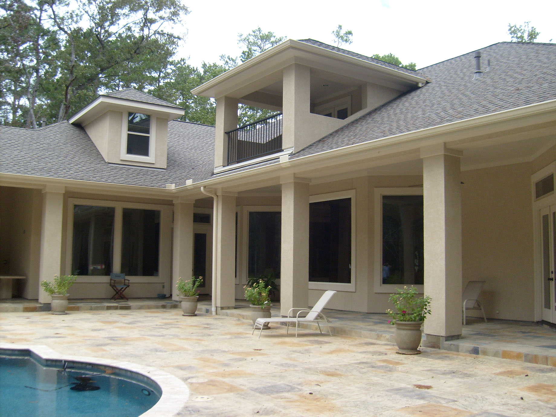 Close-up of a clean, newly installed brown seamless gutter corner and downspout